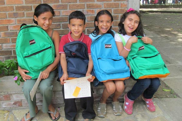 Nicaraguan children show off their new back packs